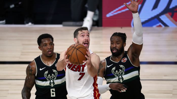 Miami Heat guard Goran Dragic shoots against Milwaukee Bucks guard Eric Bledsoe and guard Wesley Matthews during the first half of game two of the second round